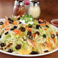 Signature Nachos  · Tortilla chips, refried beans, queso, and your choice of taco beef or roasted chicken. Toppe...