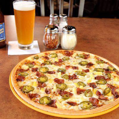 Large Spicy BBQ Chicken Pizza  · KC masterpiece BBQ sauce topped with mozzarella and smoked provolone cheese, roasted chicken breast, smoked bacon, pineapple, and jalapenos.