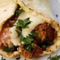 Falafel Pita Sandwich · 2 pieces of crisp, warm falafel, served with chopped parsley, tomatoes, pickles and tahini s...