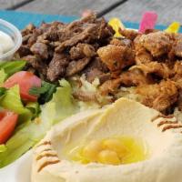 Shawarma Combination Plate · A mixture of chicken and tri-tip shawarma served with hummus, small house salad, rice, garli...