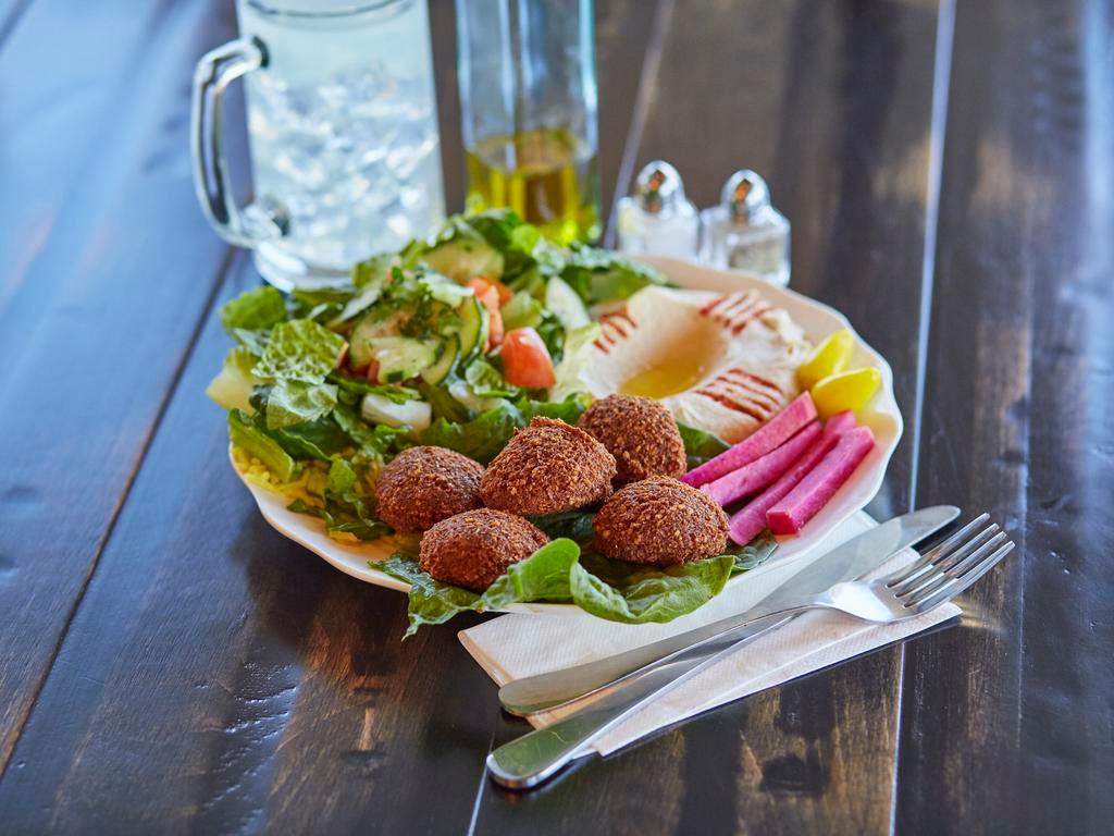 Falafel Plate · 5 pieces of crunchy falafel, hummus, small house salad and pickles, served with tahini sauce and pita bread. Vegan. Vegetarian.
