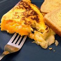 Three Cheese Omelet · Three-egg omelet featuring sharp cheddar, Swiss, and mozzarella cheeses.
