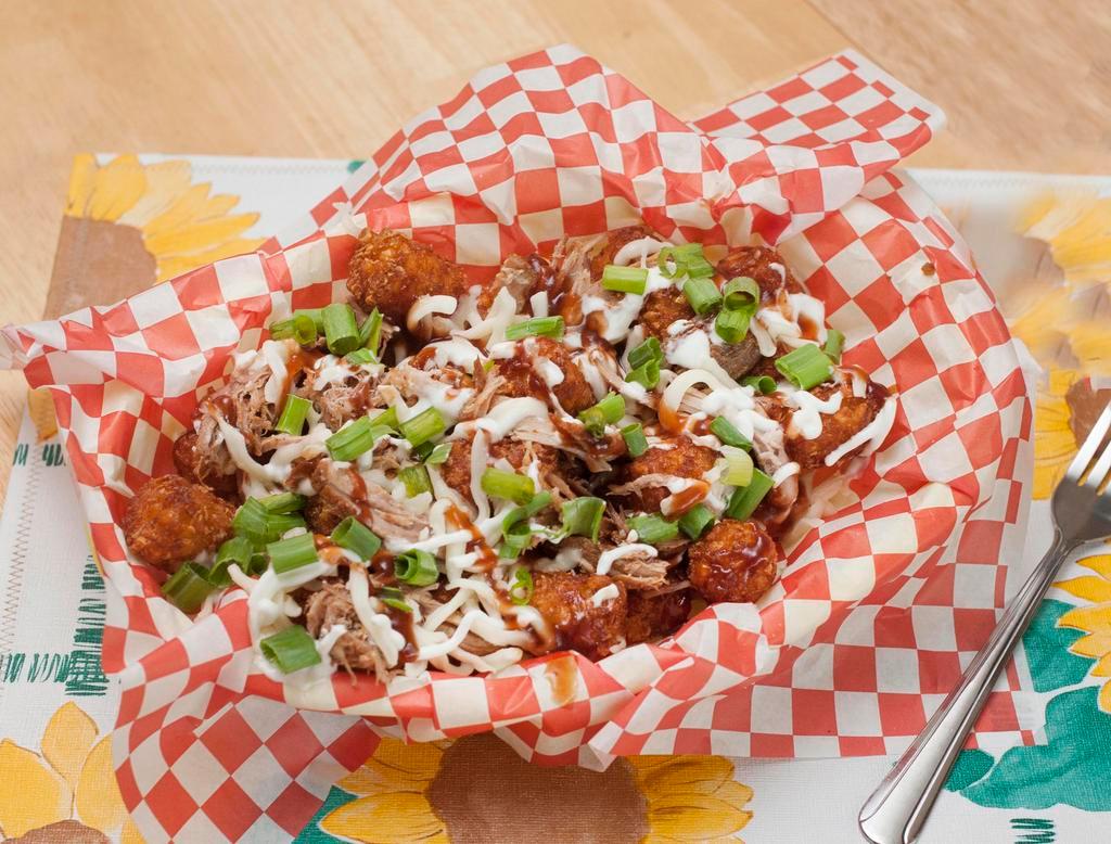 Loaded Tots Lunch · Crispy tots topped with shredded pork, mozzarella cheese, and green onions and drizzled with ranch sauce and BBQ sauce.