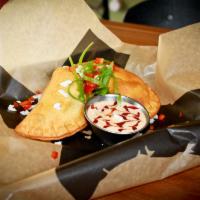 Beef Empanada · Spicy ground beef, queso and traditional spices.