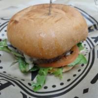 Burger · Burger with cheese, lettuce, tomato, pickles and onions.