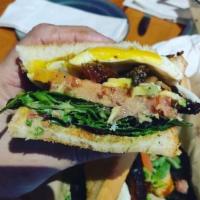 Belly LT Sandwich · Pork belly, mixed greens, tomatoes, avocado and green Chile ranch with fried egg. 