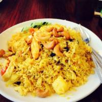 Pineapple Fried Rice · Fried rice with chicken, shrimp, pineapple, tomatoes, onions, cashew nuts, raisins and curry...