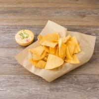 Chile con Queso and Chips · A warm cheese dip with a hint of pico de gallo, served with chips.