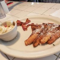 Texas French Toast · Texas French toast with 2 eggs and your choice of bacon or sausage.