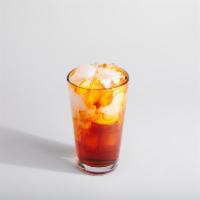 Thai Iced Tea · A blend of black tea, vanilla, and cinnamon poured over ice and topped with half & half.