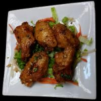 Fried Chicken Wings · Crispy deep fried chicken wings seasoned with garlic, salt and pepper. Served with sweet chi...