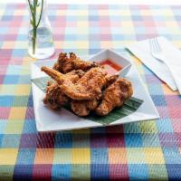 Fried Chicken Wings ·  Marinated chicken wings with Thai herbs served with sweet chili sauce.