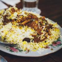 Lamb Biryani · Cubes of tender lamb cooked with basmati rice, herbs, spices, nuts, and raisins.