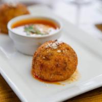 Arancini · Fried rice ball filled with ground beef and shredded mozzarella. Served with a side of tomat...