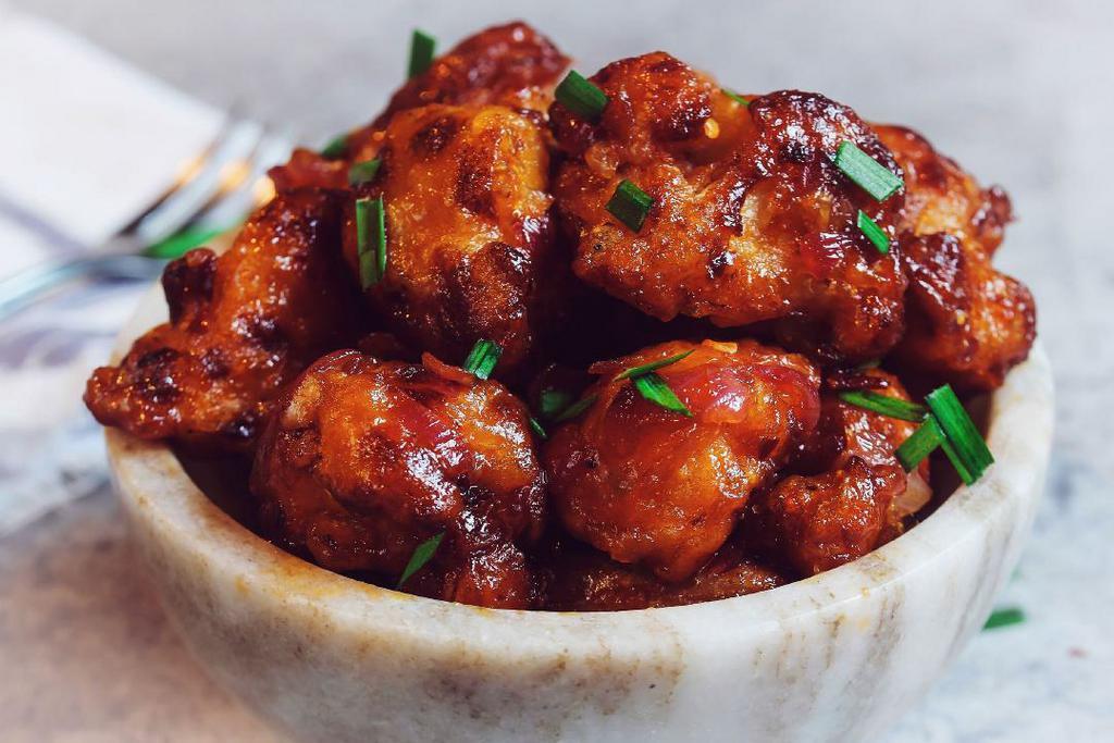 Gobi Manchurian · Indo-Chinese delight. Cut cauliflower pieces, battered, fried, and sauteed over sweet, spice & tangy Manchurian sauce.