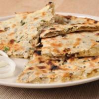 Onion Kulcha · Diced onions and light spices stuffed into the naan bread.