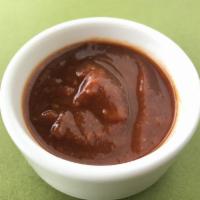 Tamarind Chutney (8 Oz) · The Purple / Light Brownish sweet sauce made with will cooked tamarind and some spices.