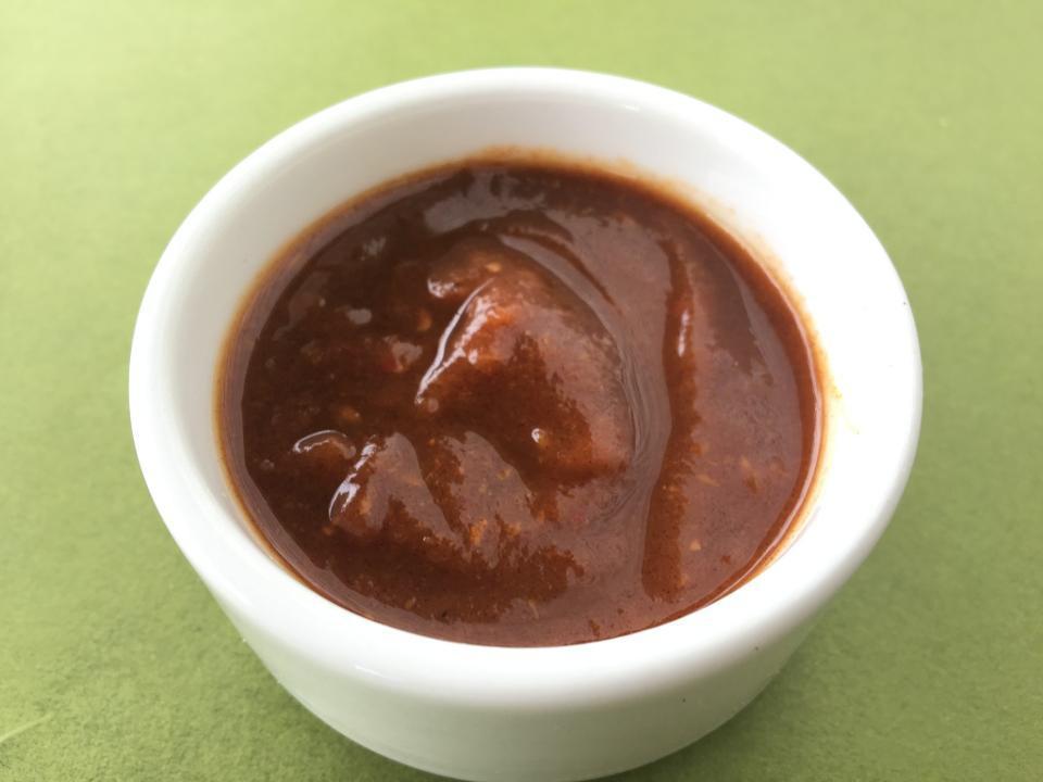 Tamarind Chutney (8 Oz) · The Purple / Light Brownish sweet sauce made with will cooked tamarind and some spices.