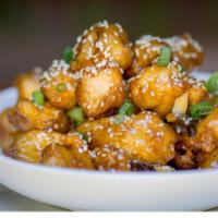 Sesame Glazed Chicken · Crispy natural chicken, sweet and tangy sesame glaze, chili pods, toasted sesame seeds.