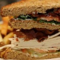 Turkey Club Sandwich · Triple decker with roast turkey, bacon, lettuce, tomato and mayo on toast.