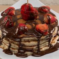 Chocolate Dipped Pancakes · Multi grain protein pancakes with dark chocolate chips topped with strawberries and chocolat...