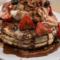 Rocky Mountain Pancakes · Multi grain protein pancakes topped with vanilla froyo, strawberries, blueberries, pecans, a...