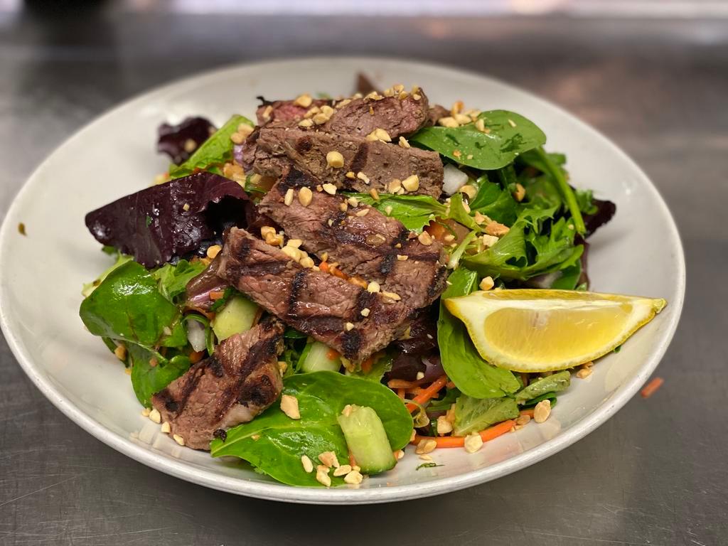 Thai Steak Salad · DRESSING COMES ON THE SIDE

New York Strip Steak, Mixed Greens, Tomatoes, Cucumbers, Carrots, Red Onions, Peanuts, Mixed Herbs with Chili Lime Dressing