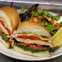 Grilled Chicken Sandwich · Mozzarella, arugula, roasted red peppers, tomatoes, and pesto aioli on grilled focaccia. Ser...
