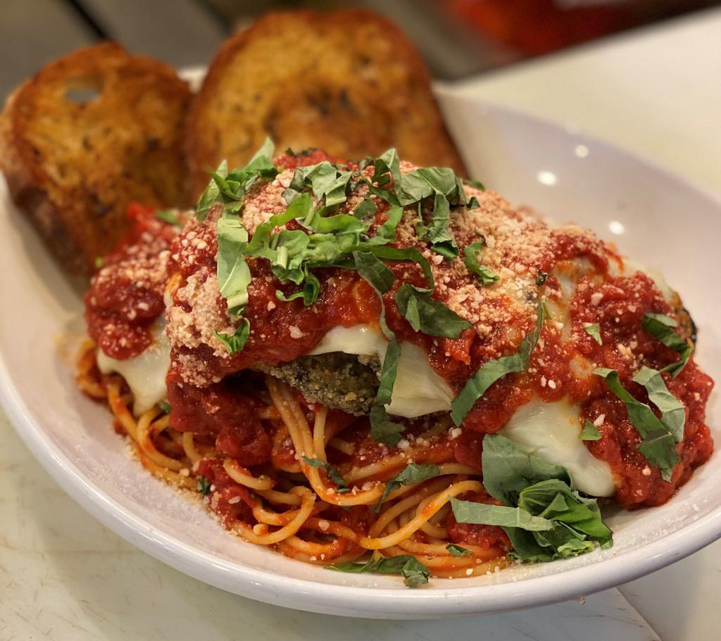 Eggplant Parmigiana · Breaded Eggplant with Melted Mozzarella Served Over Spaghettini with Marinara Sauce  Served with Garlic Bread