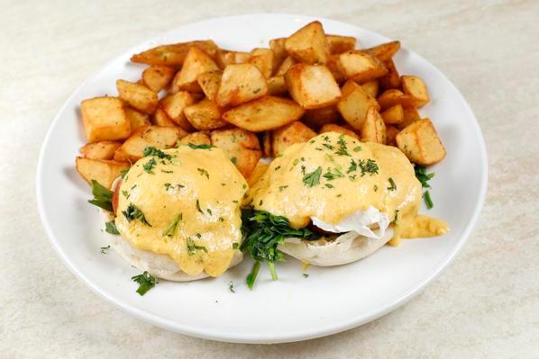 Florentine Benedict · Grilled tomatoes and spinach. Served with two poached eggs, Hollandaise sauce on toasted English muffin with rosemary garlic potatoes. 