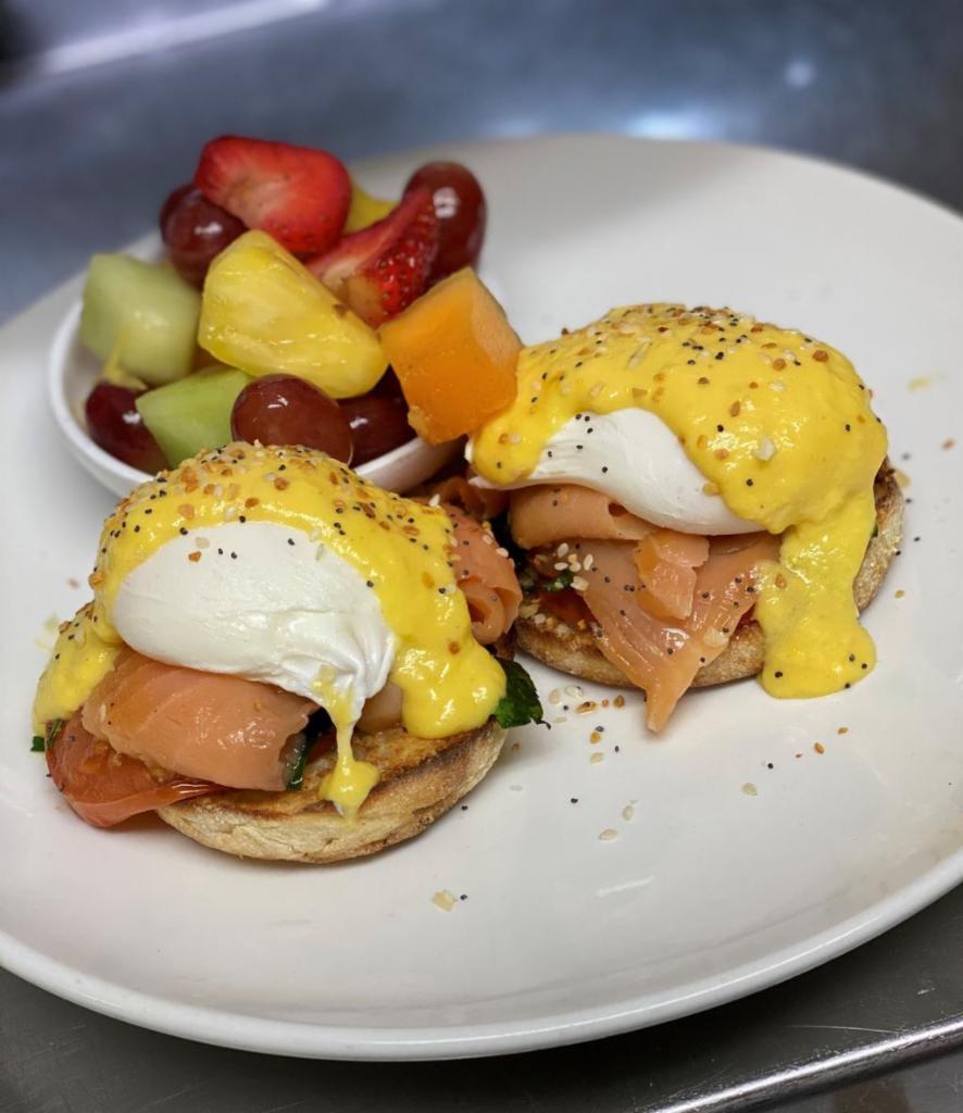 Lox Benedict · Two Poached Eggs, Smoked Salmon, Grilled Tomatoes, & Spinach, Hollandaise Sauce On a Toasted English Muffin with House Potatoes.