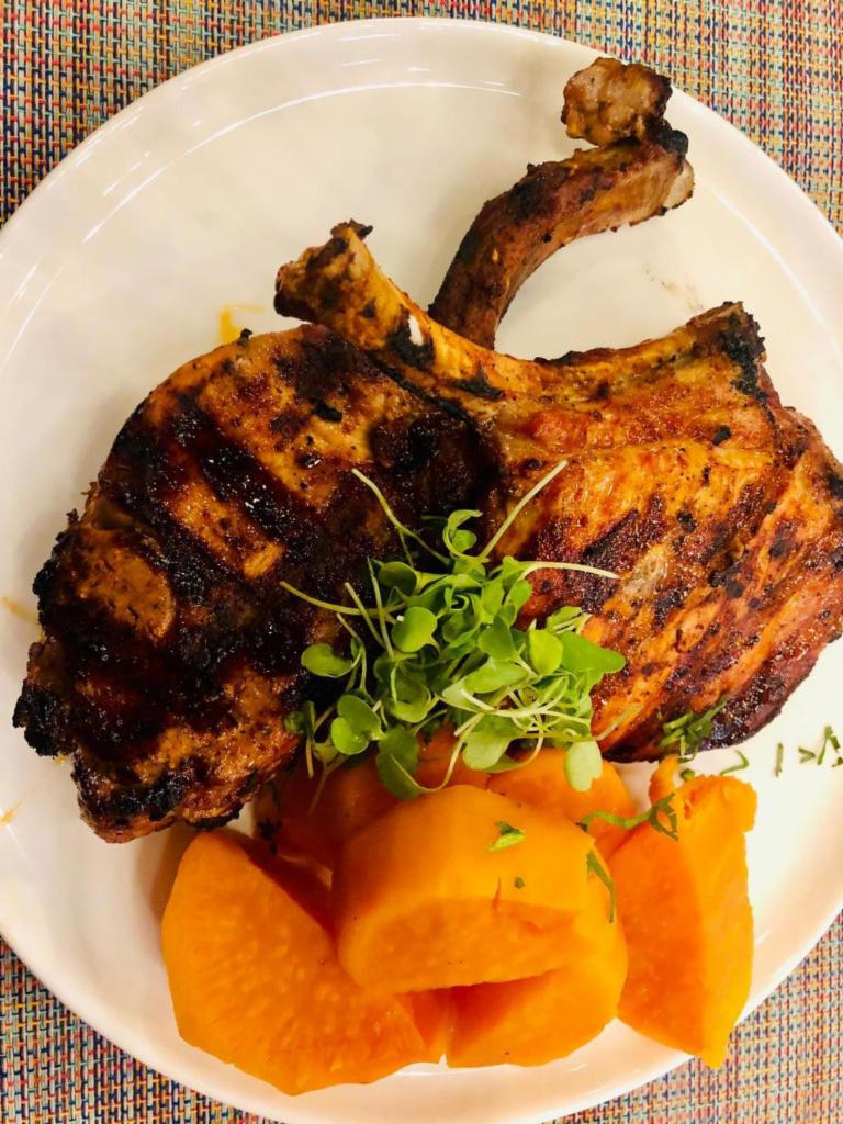 Pork chops · Pork chops marinated in peruvian spices served with our signature jasmine rice, house salad and sweet potatoes.