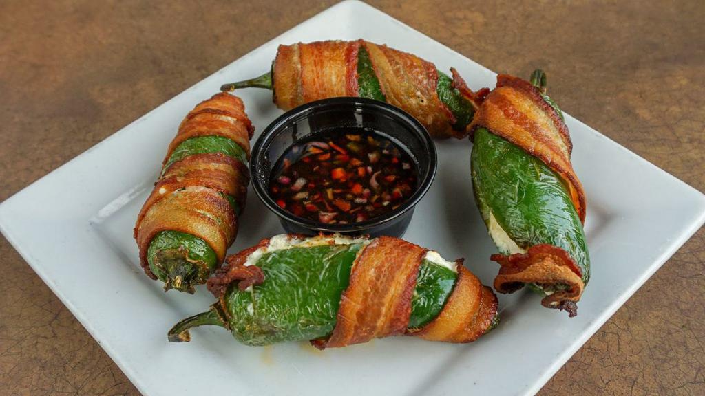 Jalapeño Poppers · Jalapeños wrapped in bacon, stuffed with mozzarella and cream cheese & served with spicy jam