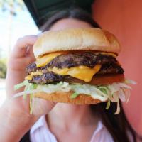 Double Cheeseburger · Two 100% beef patties, each with a slice of American cheese, served on a grilled bun with ma...