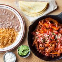 House Fajitas · Marinated in house fajita sauce, yellow, green, red bell peppers, onions, guacamole, Mexican...