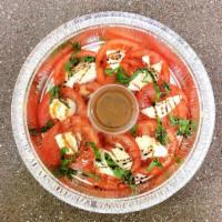 Caprese Salad · Slices of fresh mozzarella cheese, ripened tomatoes, fresh basil leaves and topped with a da...