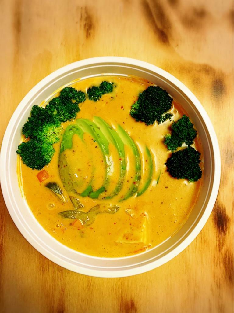 Avocado Curry · House red curry with chicken, carrot, bell pepper, broccoli topped with fresh avocado.