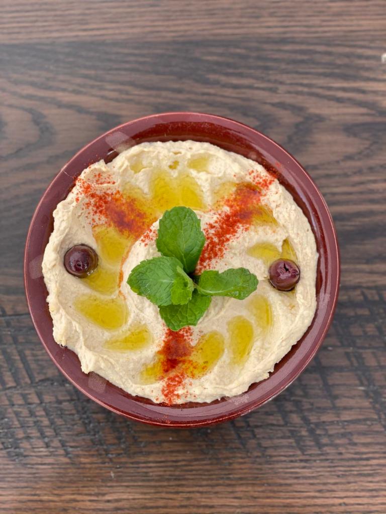 Hummus · Garbanzo beans with tahini (sesame seed oil), garlic and lemon juice.
Served with fresh tanour bread.