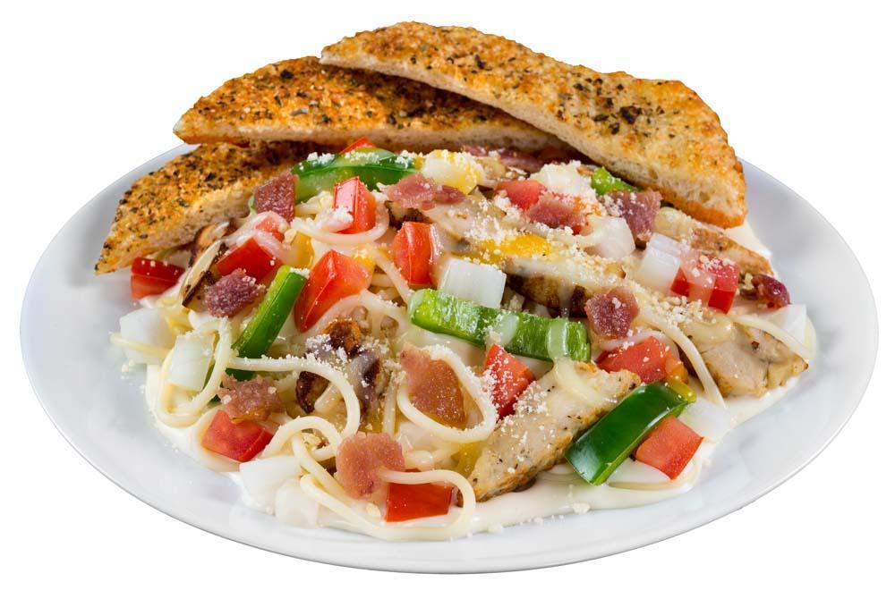 Chicken Alfredo · A juicy all-natural grilled chicken breast over spaghetti smothered in creamy Alfredo sauce and topped with fresh tomatoes, sauteed onions, and green peppers, crispy bacon, sharp Parmesan, our signature gourmet cheese blend, then baked to perfection.  All gourmet pasta dishes come come with a side of garlic bread.