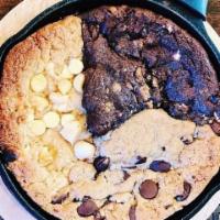 Warm Cookies · Trio of chocolate chip, white chocolate macadamia and s’mores baked in a cast iron pan. Cont...