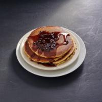 Chocolate Chip Pancakes · Four large cakes filled with small chocolate chips. Topped with whipped cream and choice of ...