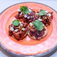 Rotisserie Beet Tostada (4pcs) · macadamia nut salsa, sheep's milk feta, orange, pickled onions, pepitas