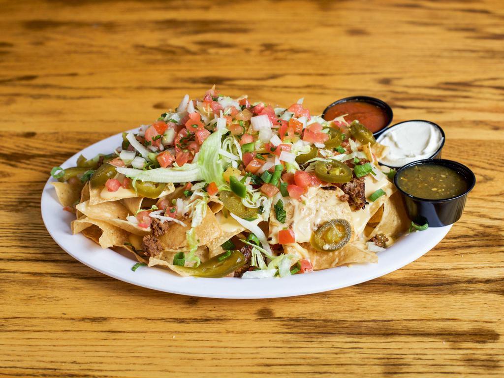 Nachos · Chicken, beef, BBQ pulled pork or black beans atop tortilla chips with queso, pico de gallo, lettuce, green onion, jalapenos, sour cream and salsa.