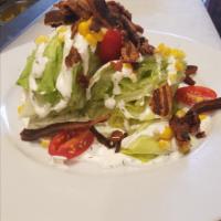 Wedge Salad · Iceberg lettuce, cherry tomatoes, charred corn, bacon and buttermilk ranch.