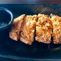 Tonkatsu Pork Cutlet · Traditional Japanese tonkatsu with separate sauce.