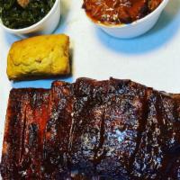 1/2 Rack Baby Back Rib Platter · 1/2 rack Baby back and 2 small homemade sides with cornbread. Served with 1 Pigsty house sau...