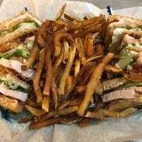 Turkey Club Sandwich · Triple decker club with sliced turkey breast, lettuce, tomato, mayo and crispy bacon. Served...