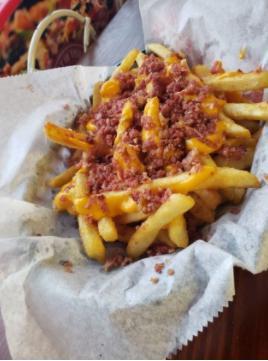 Beef Bacon Cheese Fries · Delicious seasoned french fries topped with melted cheese and bacon bits.