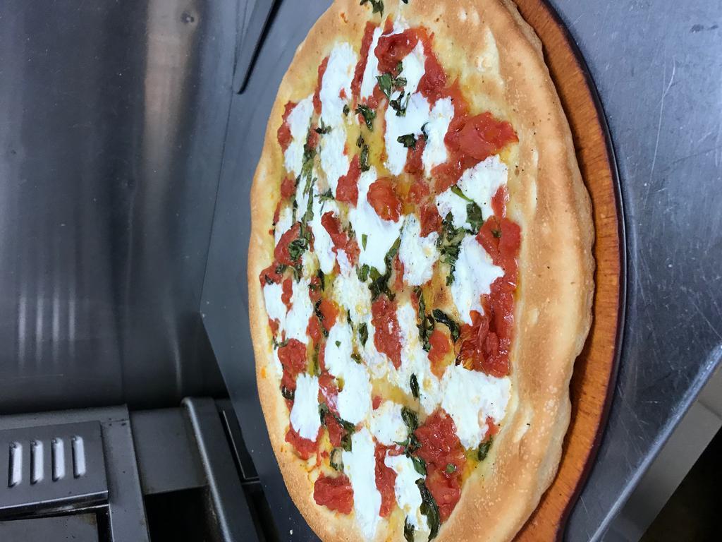 Margherita Pizza · Fresh mozzarella, fresh tomatoes and fresh basil, drizzled with extra virgin olive oil.