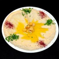 Hummus · Blended chickpeas with tahini sauce, lemon, and salt. Served with pita bread. 